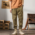 Men's cotton harem pants with ankle banded legs in khaki colour showing zip placket fly detail