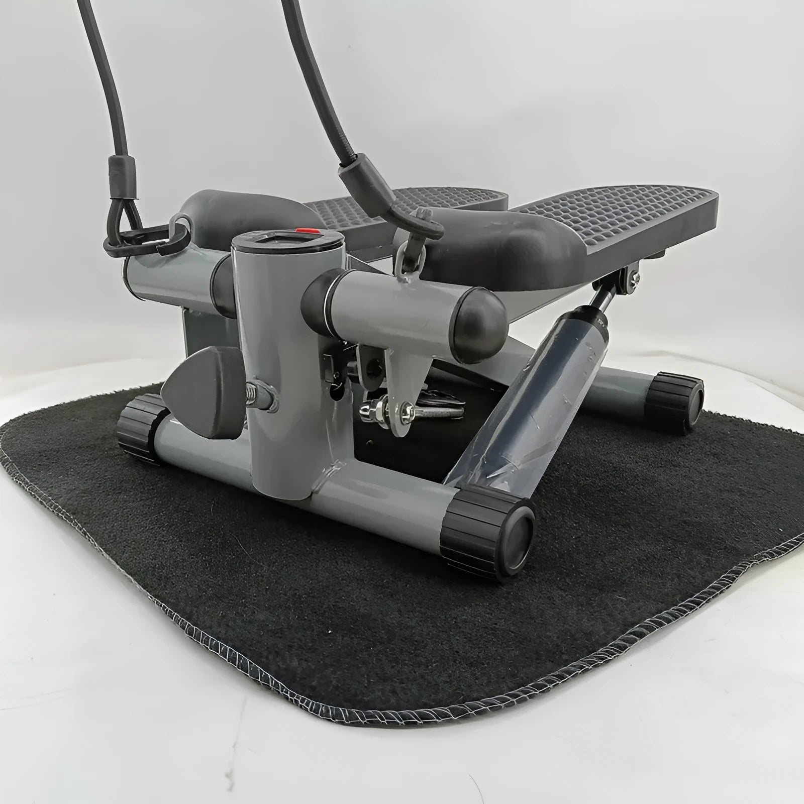 Silver grey hydraulic resistance mini treadmill and pedal machine for home gym waist slimming workouts.