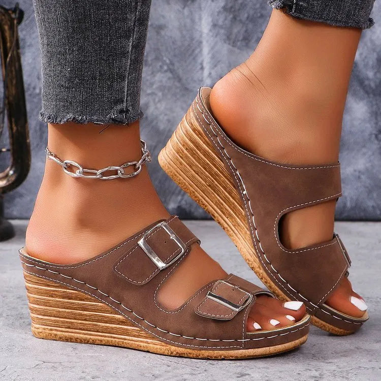 Women's creamy white beach slippers with a silver buckle on the strap