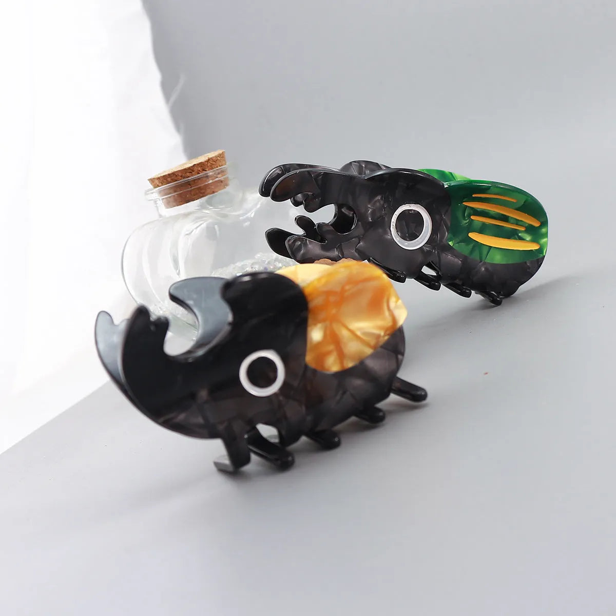 Handmade cellulose acetate Beetle Grip educational tool showing cartoon beetle and caterpillar designs