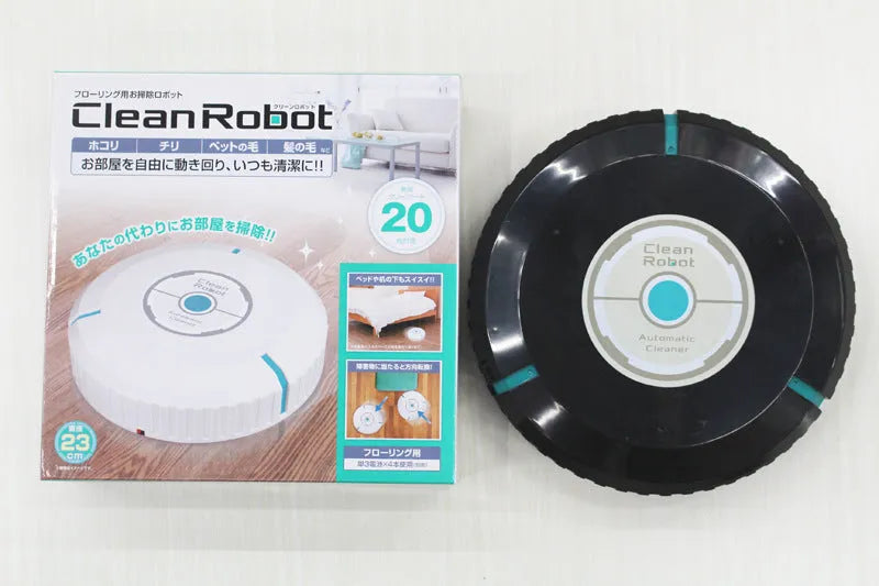 Black and white AC Sweeping Robot automatic vacuum cleaner on a hardwood floor.