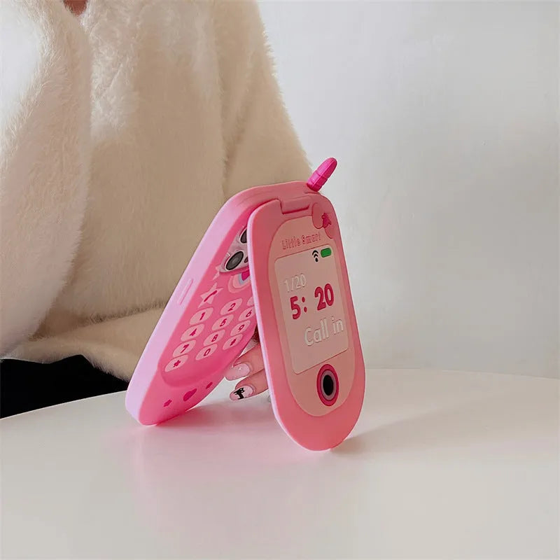 Light pink silicone flip phone shape case with mirror for iPhone, showing cute cartoon style.
