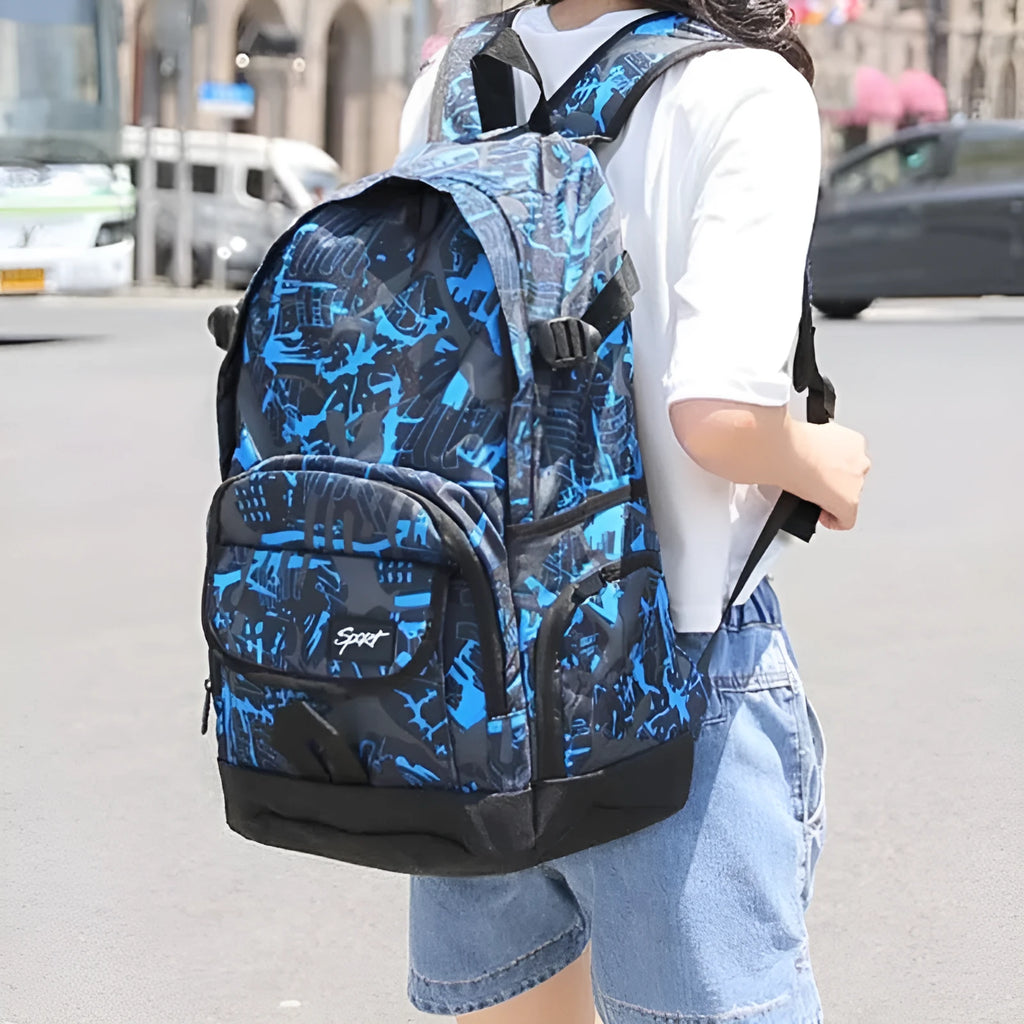 Classic blue nylon backpack with large main compartment and adjustable straps on a plain background.