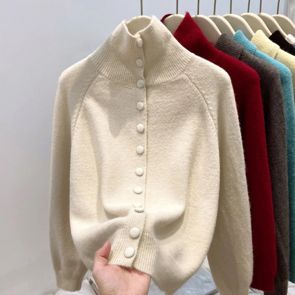 Women's loose fit turtleneck cardigan in thick polyester knit, button front, available in six colours including red and blue