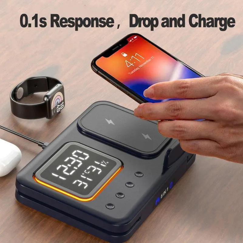 Black and white 5-in-1 wireless charging dock station with phone, watch and earphones charging, showing LED clock display.