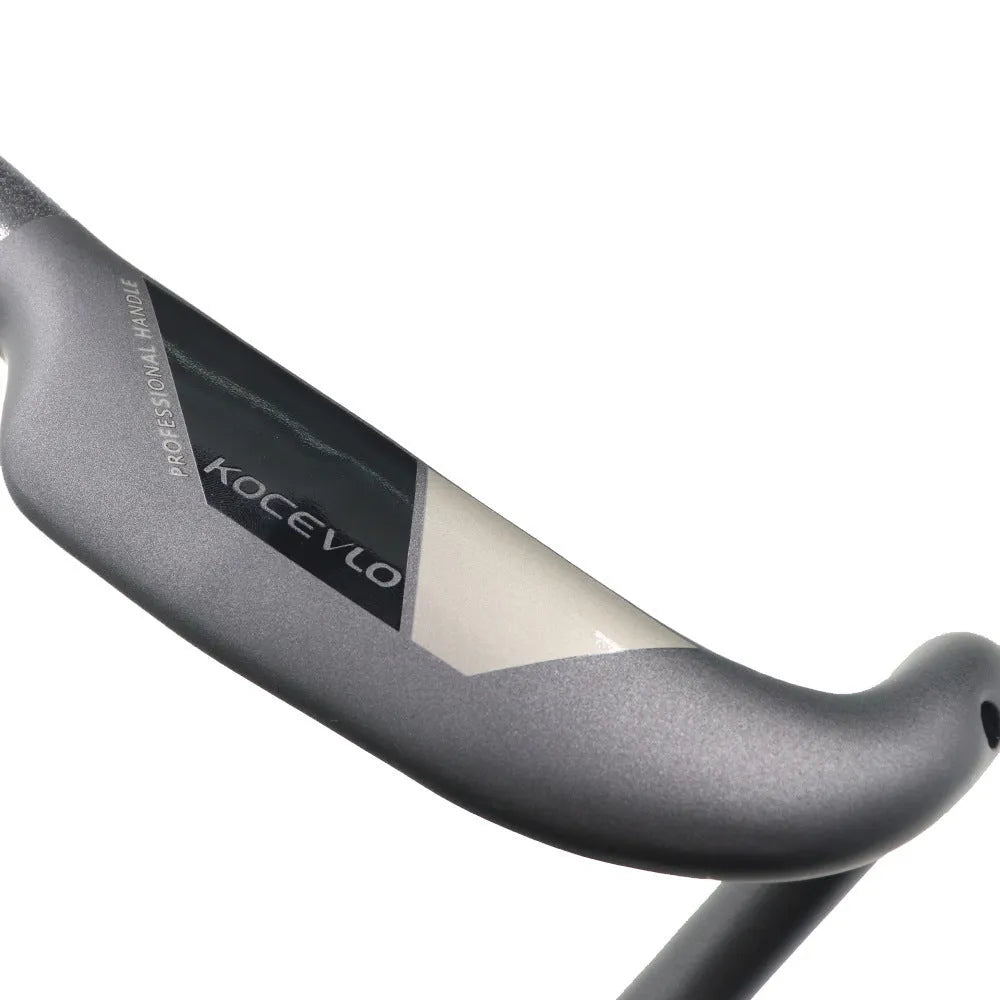 Matt black carbon fibre bent road bicycle handlebar shown from above.