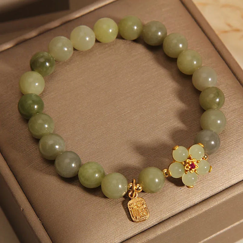 A grey jade and alloy casual bracelet for women, showing its unique design.