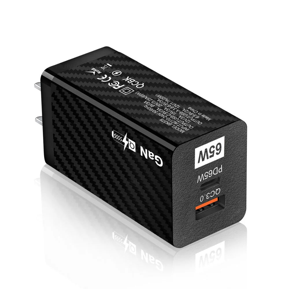 65W GaN fast charger showing compact size next to laptop with USB-C cable