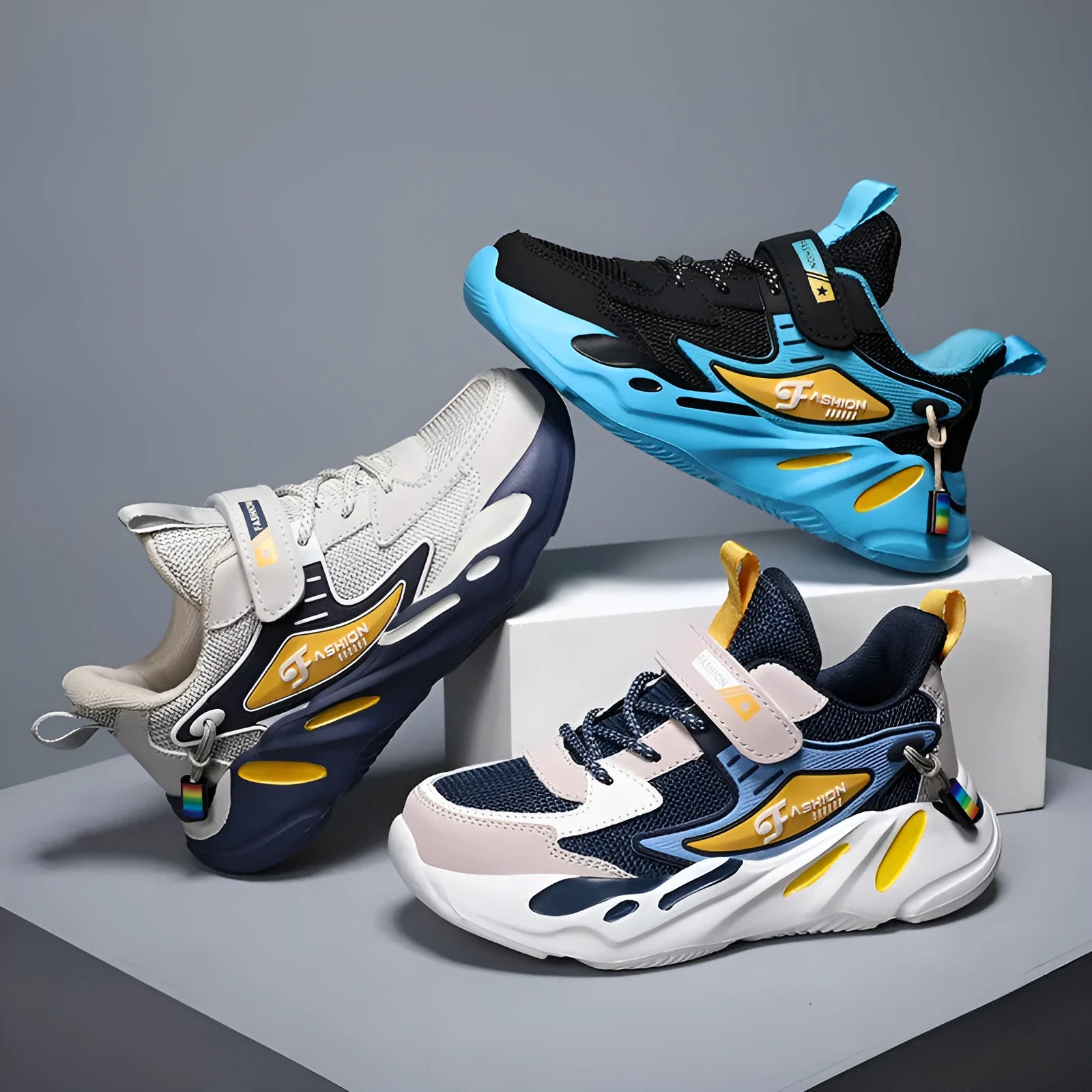 Boys' blue and black platform sports running shoes with Velcro strap on a hard ground surface.