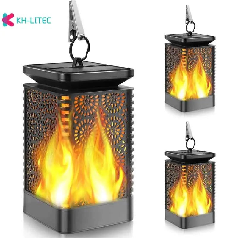 Four black solar-powered hanging torch lights with flickering flame LED effect for garden decoration