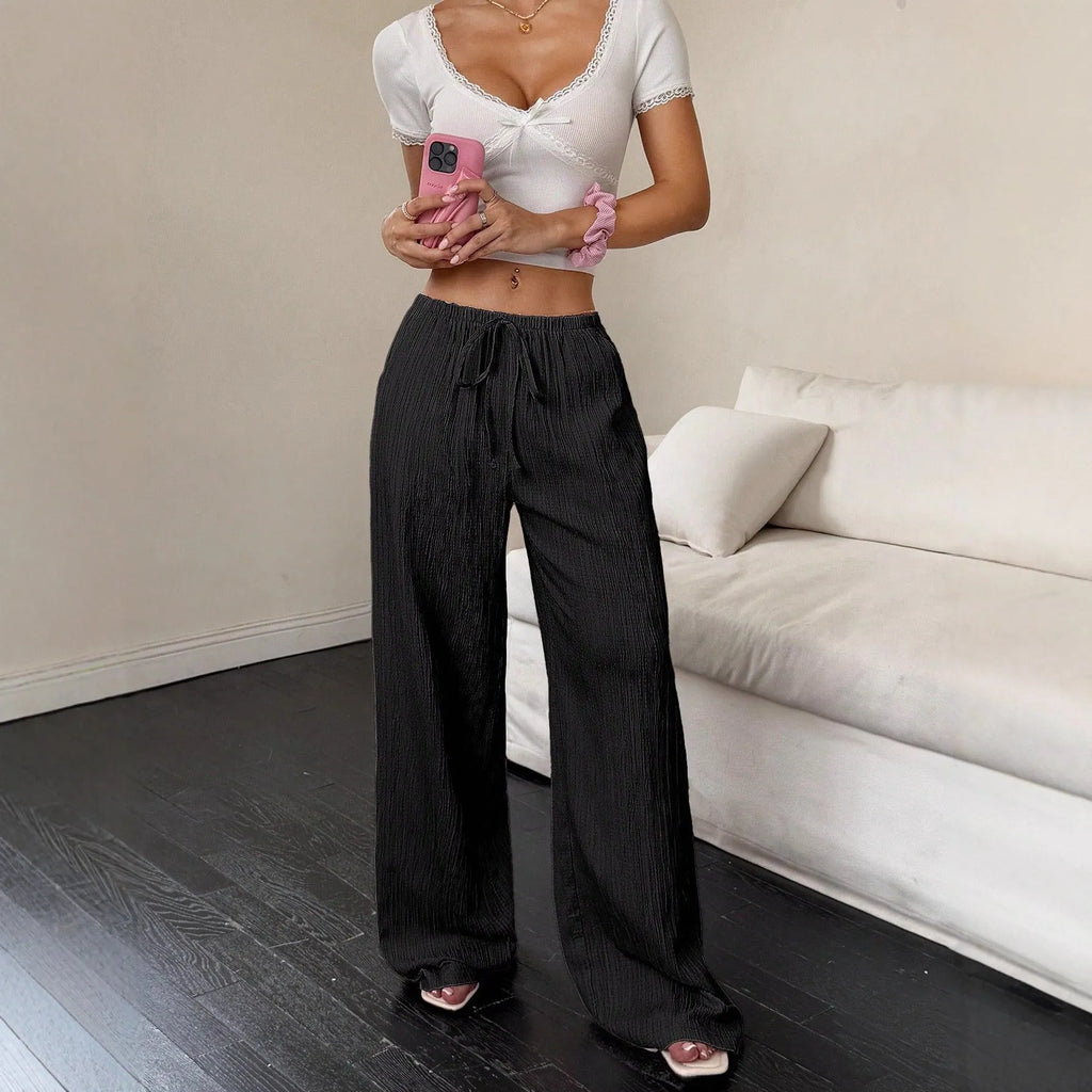 Women's black wide leg trousers with lace-up waist trimming detail on mid waist