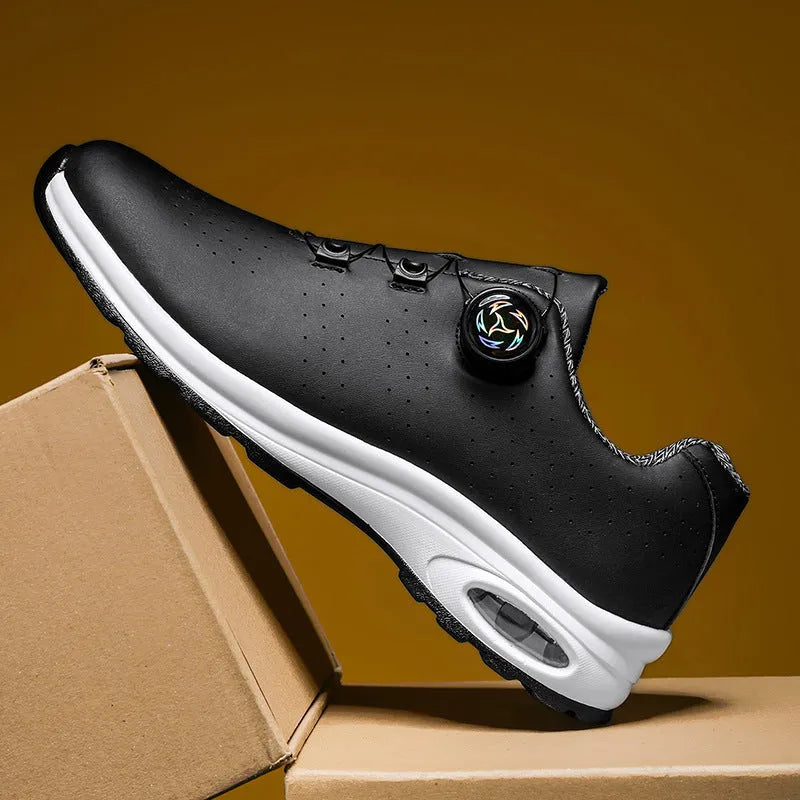 Black and white low-top casual tennis shoes with mesh upper, cross shoulder straps, and flat composite sole.