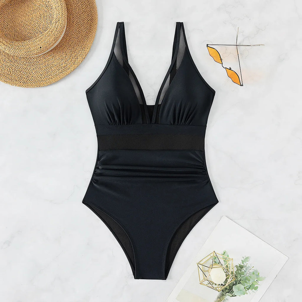 Black women's one-piece swimsuit with mesh halter neckline and briefs style bottom.