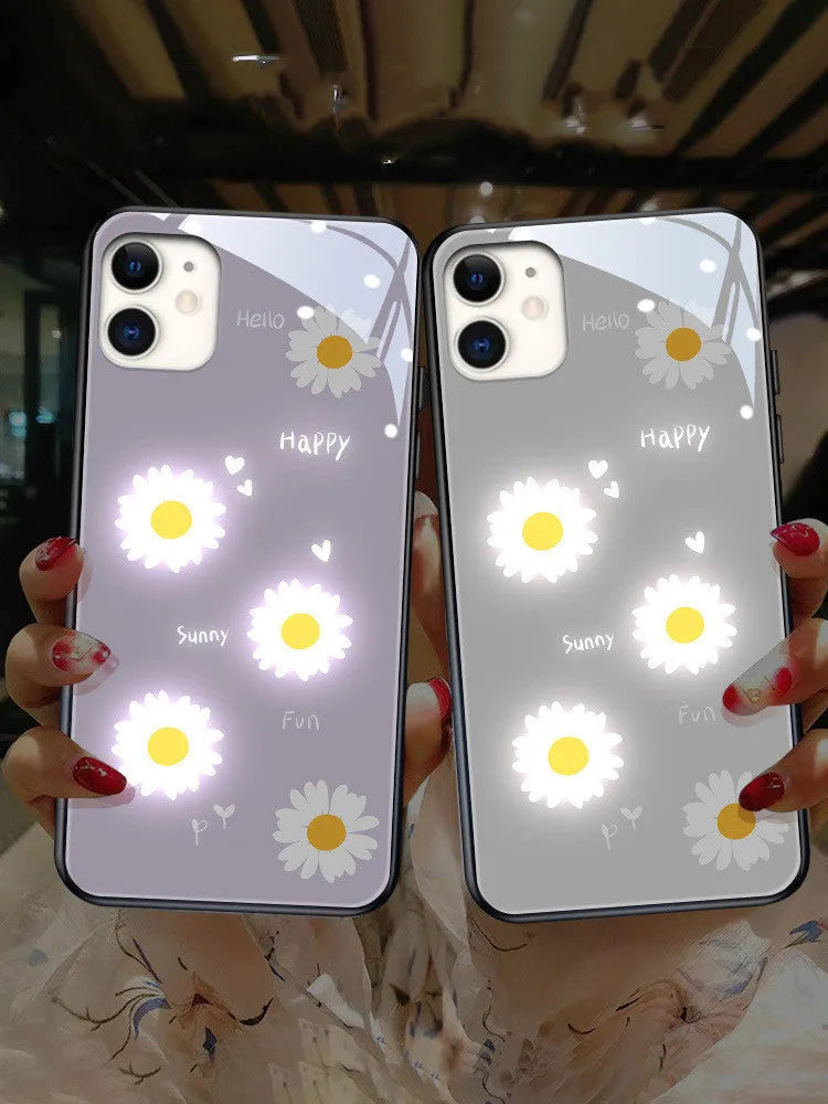 Luminous white daisy design iPhone case with voice-activated colour lights on a phone