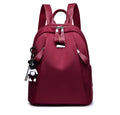 Medium Oxford cloth rucksack in wine red colour showing internal organisation pockets