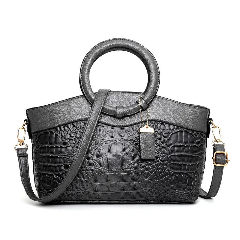 Fabric women's handbag showing multiple zipper compartments and organisational pockets