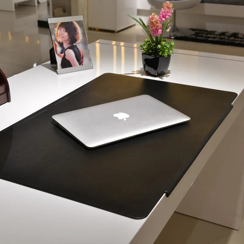 Large black PVC computer desk mat 700x450x3mm with non-slip base on a wooden desk