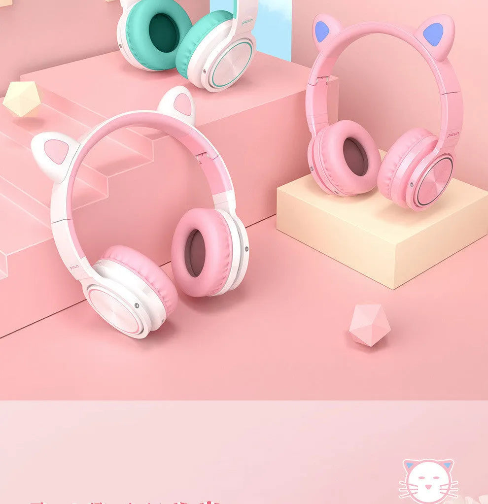 Pink and white Bluetooth over-ear headphones with braided cable and built-in microphone