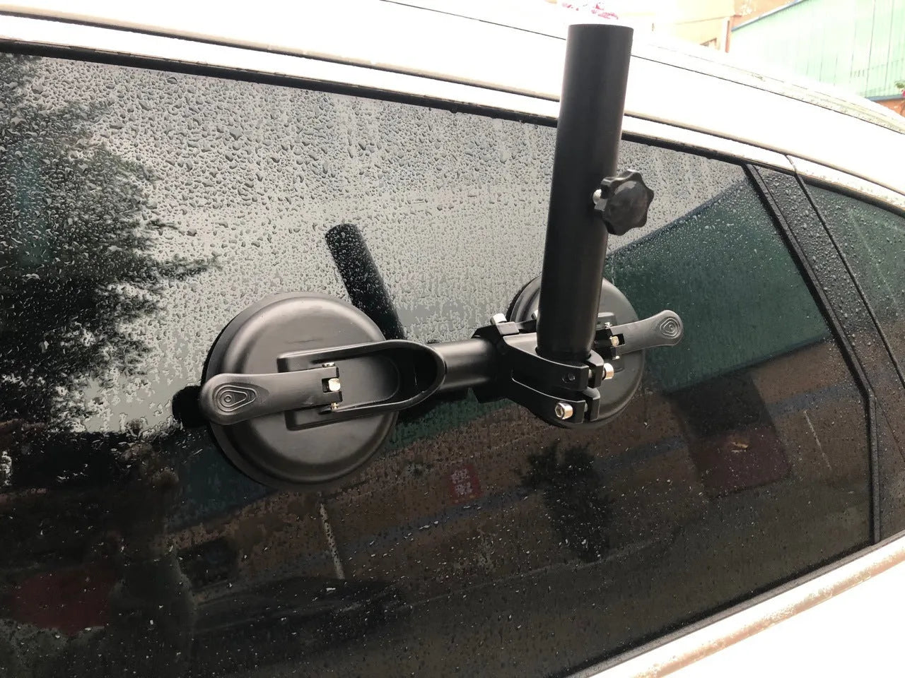 Black off-road car sucker mount with rubber suction cup for attaching flags to vehicle windows.