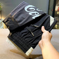 Black men's cropped casual trousers with an ankle band, made from ultra-thin cotton fabric.