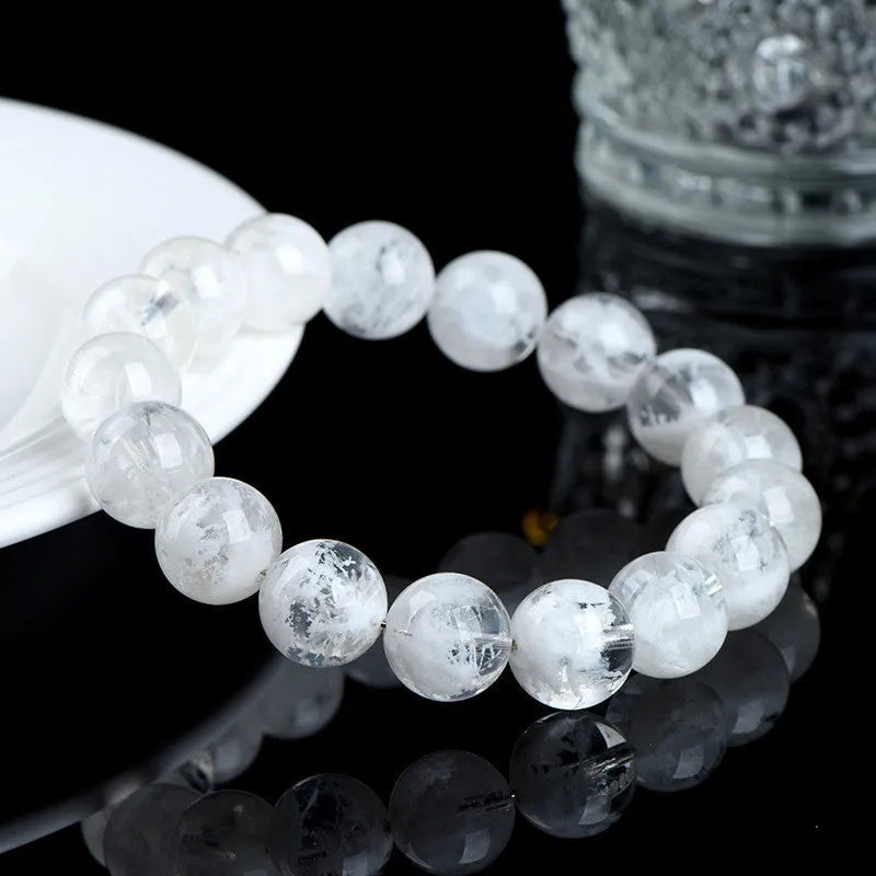 Natural blizzard snowflake crystal bracelet with round beads showing Ruyi and Xiangyun design elements