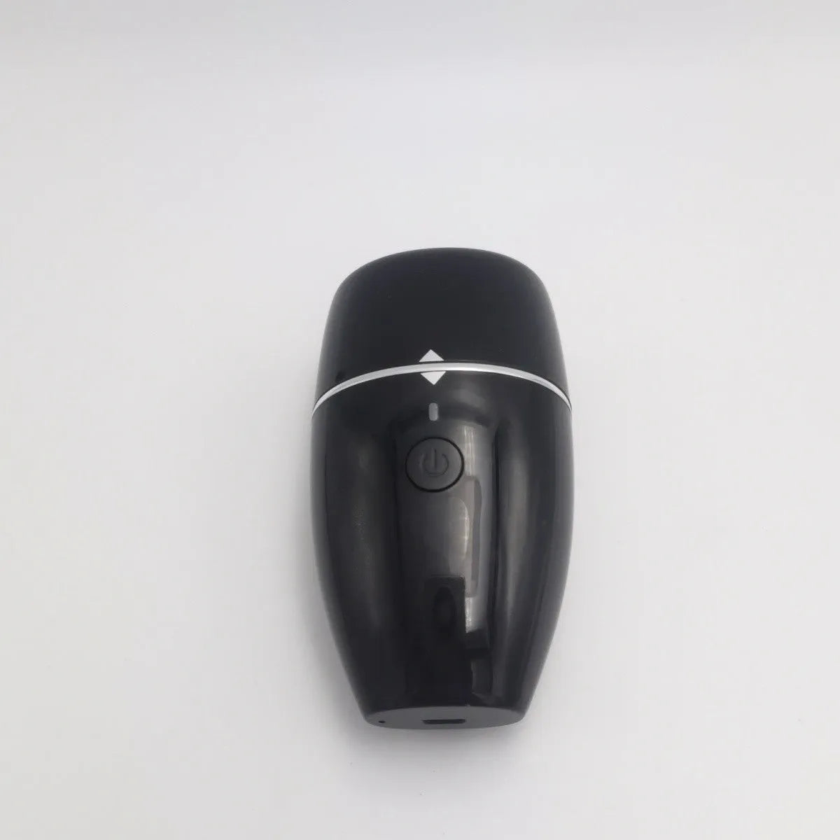 Black and white electric lip plumper device with silicone tip and USB cable on a plain background.