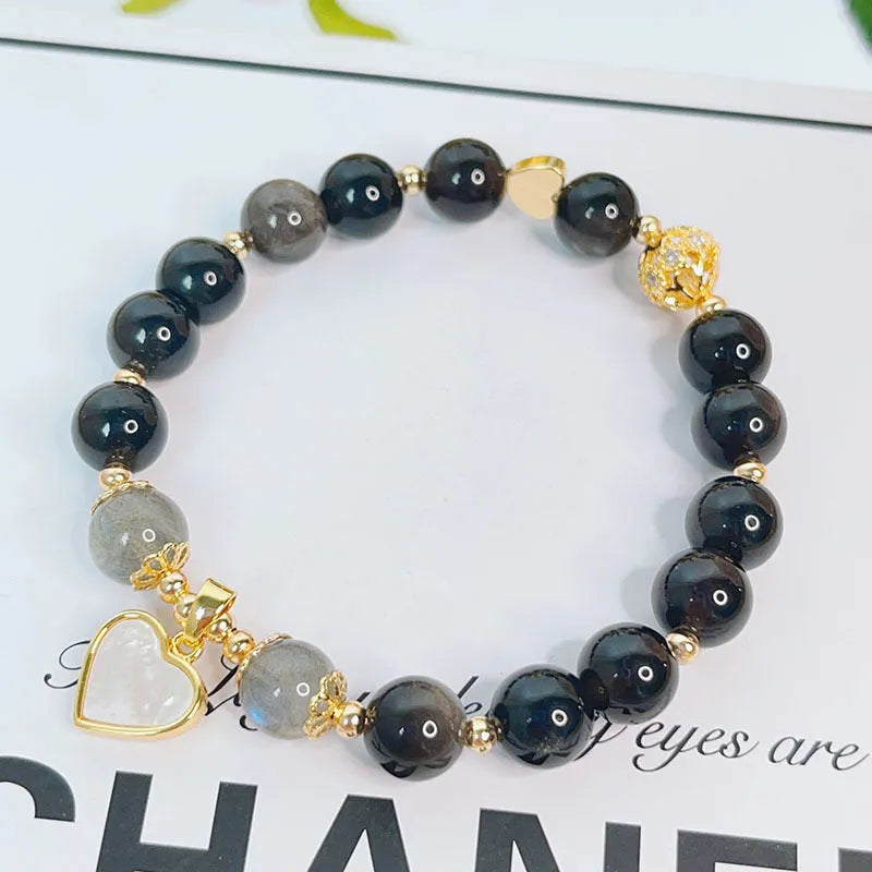 Silver stone bracelet with electroplated finish showing floral, love heart, and star charm designs