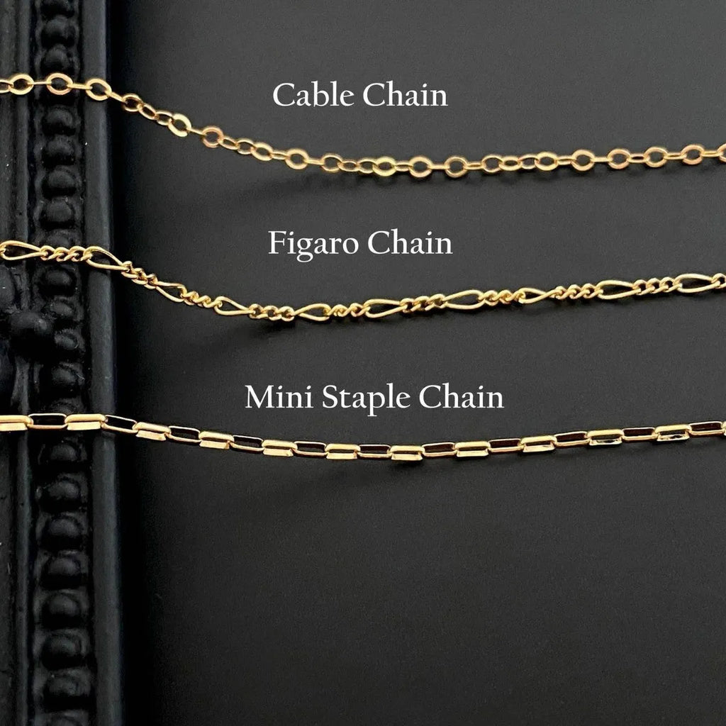 A ghost pendant necklace on a twisted stainless steel chain, showing the titanium steel electroplated pendant.