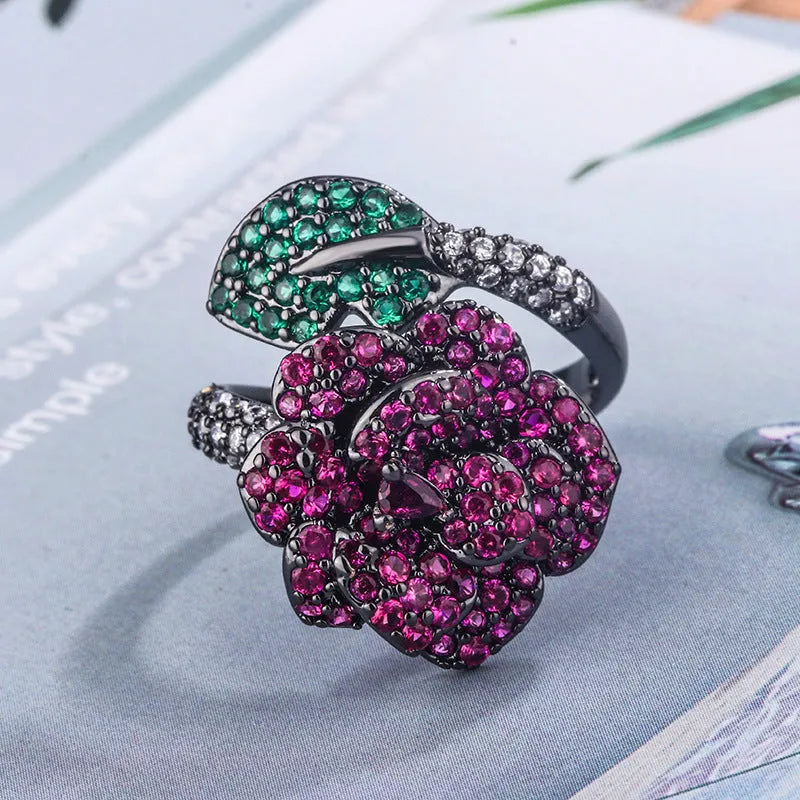 Black gold geometric flower ring with simulated red corundum centrepiece on copper base