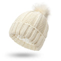 Women's knit beanie hat with faux fur pom pom and satin lining in wine red colour.