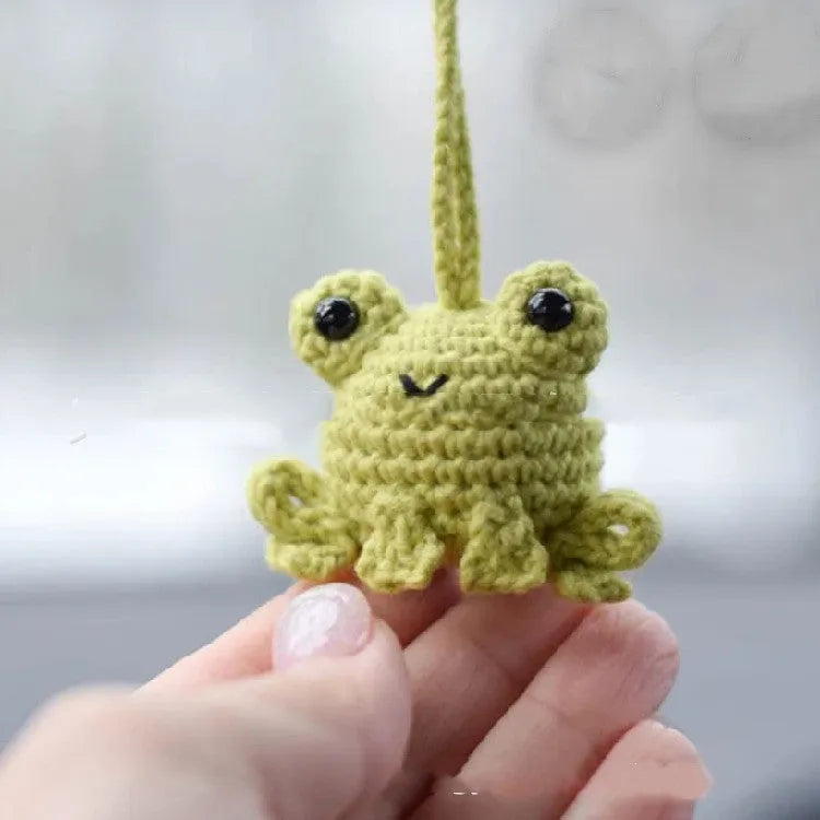 Green handmade woven plush frog car pendant hanging, showing 15cm length and cartoon style.