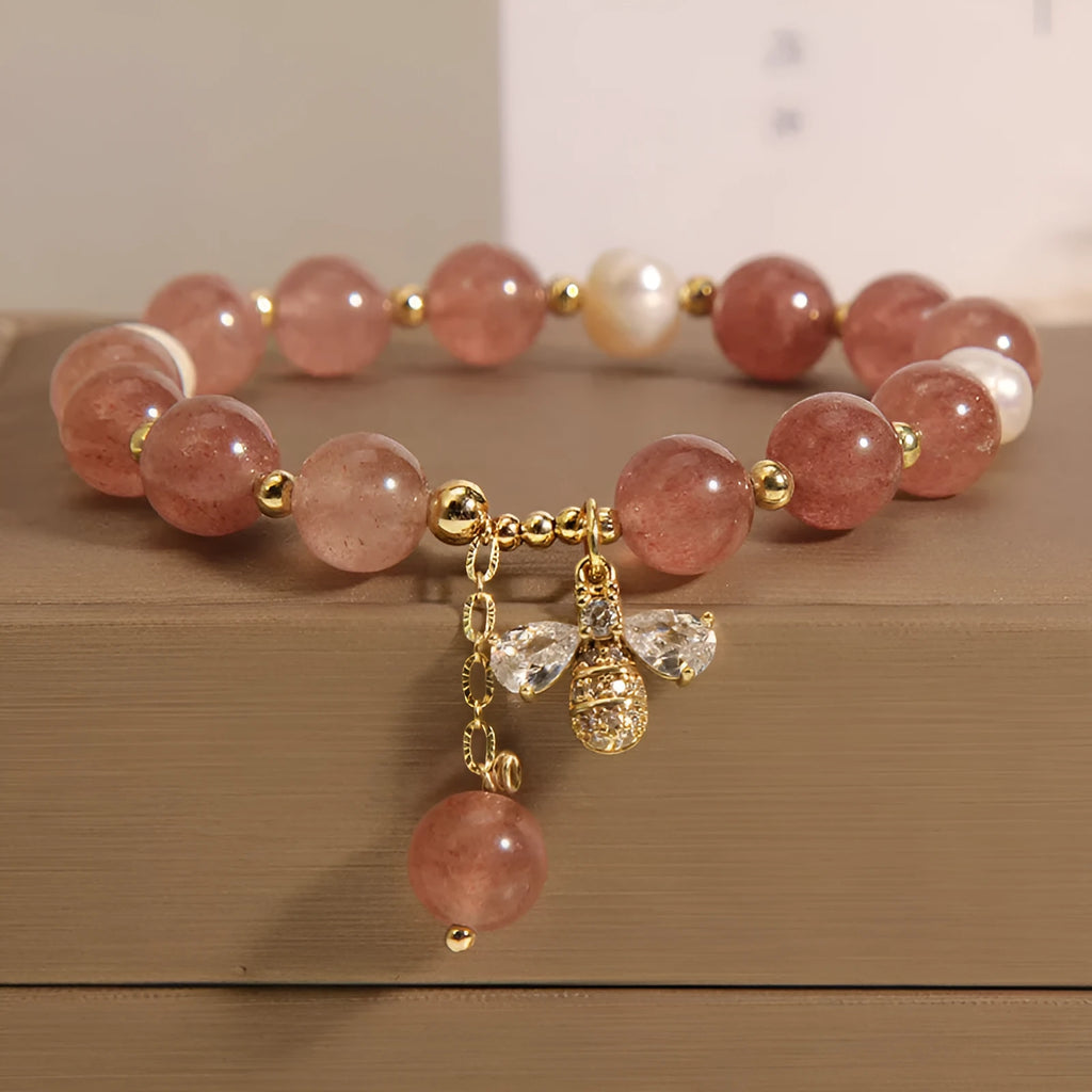 Freshwater pearl and strawberry quartz bracelet with zircon accents on wrist