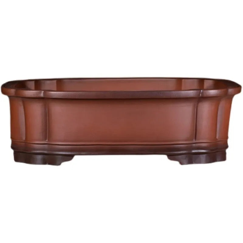 Large antique-finish purple clay flowerpot with raised tree stump and floral design.