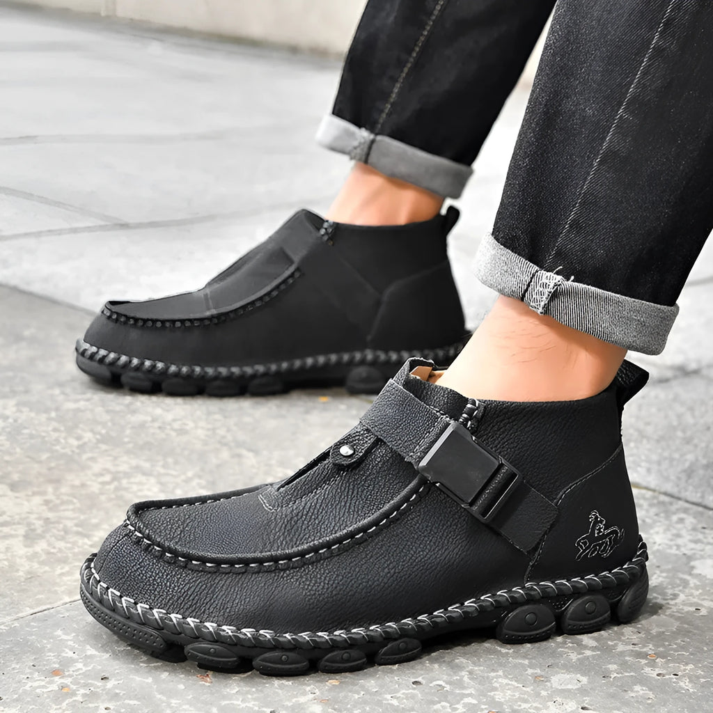 Casual black PU leather slip-on shoes with visible handmade stitching and a flat sole.