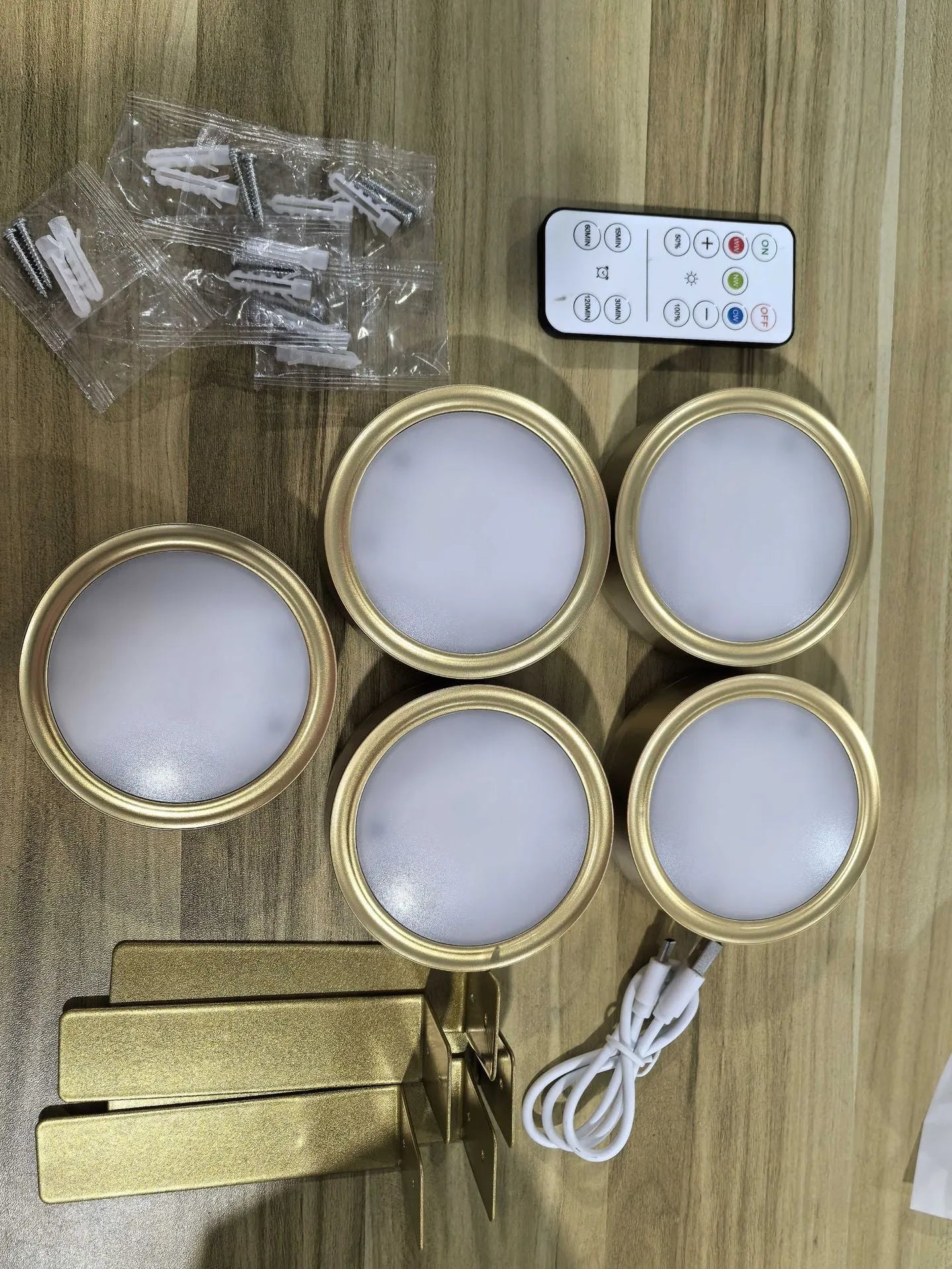 Black, white, and gold magnetic LED lamps with remote control for wall and painting lighting.