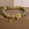 A grey jade and alloy casual bracelet for women, showing its unique design.