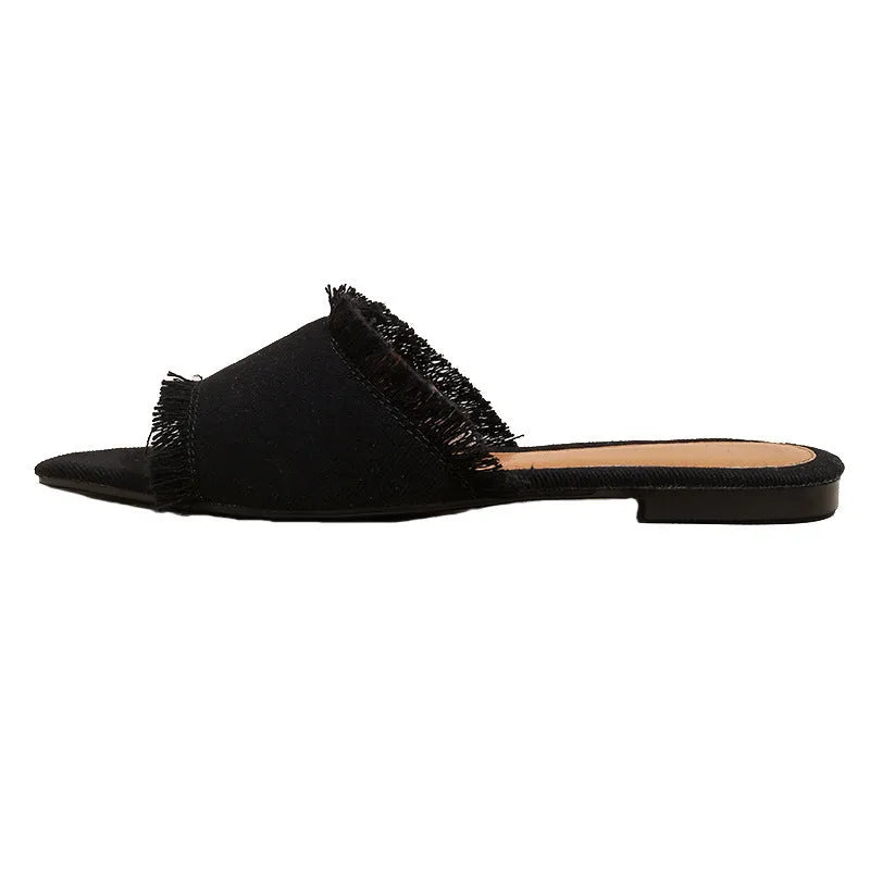 Women's denim flat slippers with a tassel, leather lining, and a lightweight PVC sole.