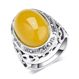 Geometric fluorescent beeswax alloy ring in antique silver amber colour on a grey background.
