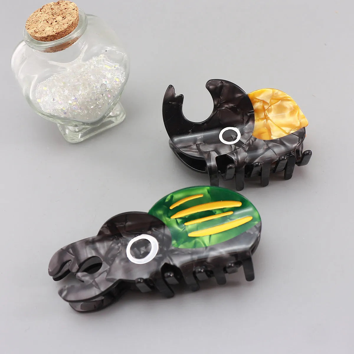 Handmade cellulose acetate Beetle Grip educational tool showing cartoon beetle and caterpillar designs