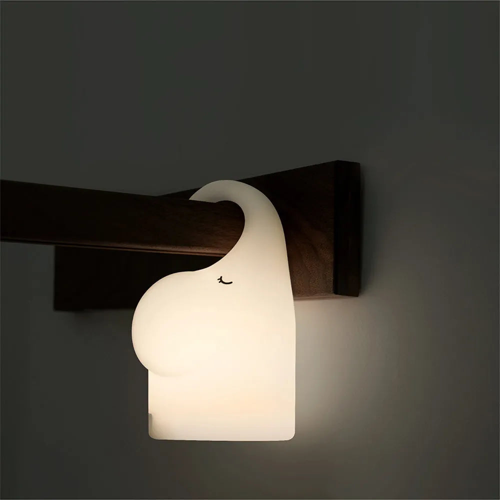 Elephant-shaped silicone night light with warm white LED illumination measuring 96mm wide by 151mm high