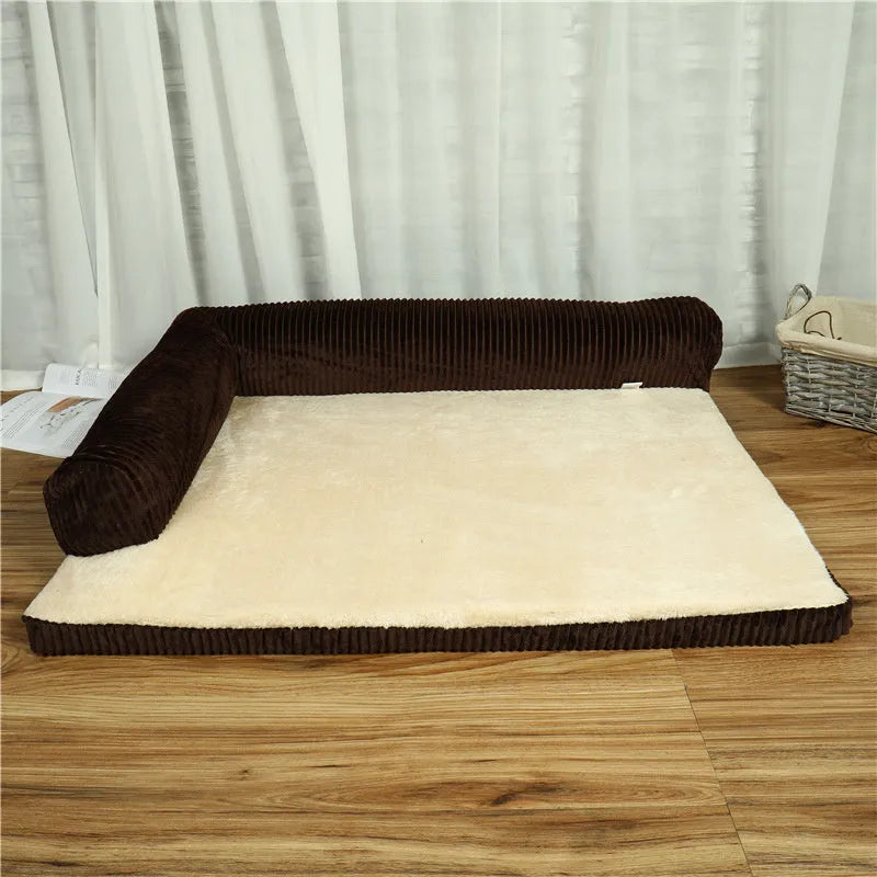 Grey corduroy dog sofa bed with raised sides and a non-slip base on a wooden floor.