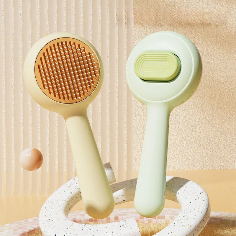 Green cat grooming brush with stainless steel teeth and non-slip handle for pet hair removal