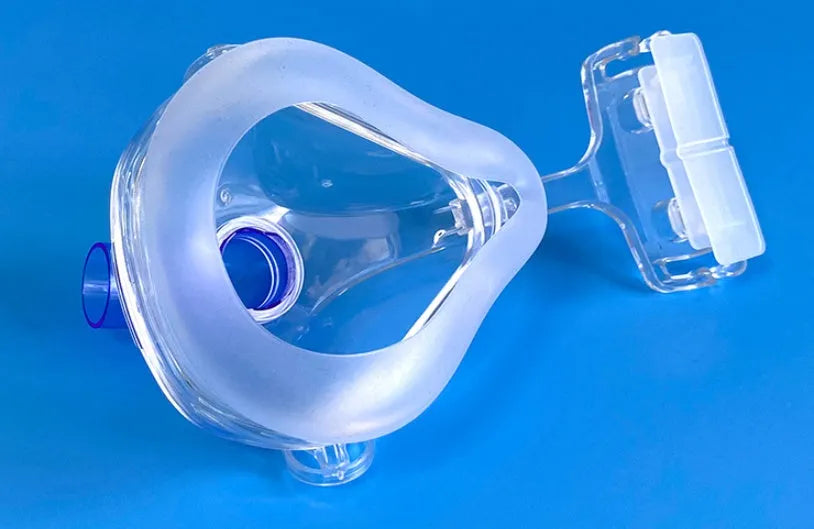 Transparent CPAP breathing mask with silicone seal, headgear, and two elbow connector options