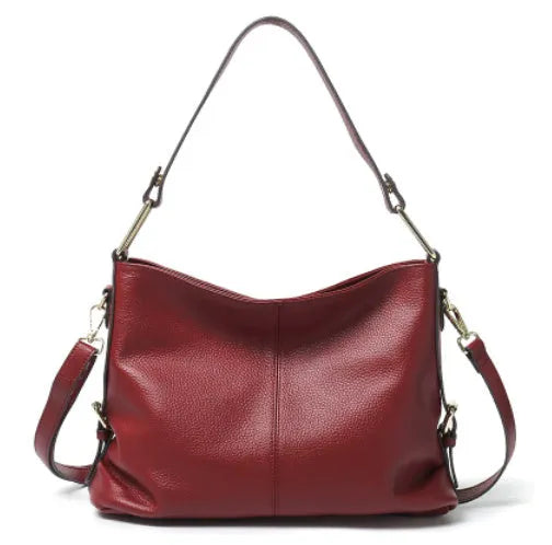 Genuine leather vertical square crossbody bag in black, showing front sandwich pocket and sewing line details.