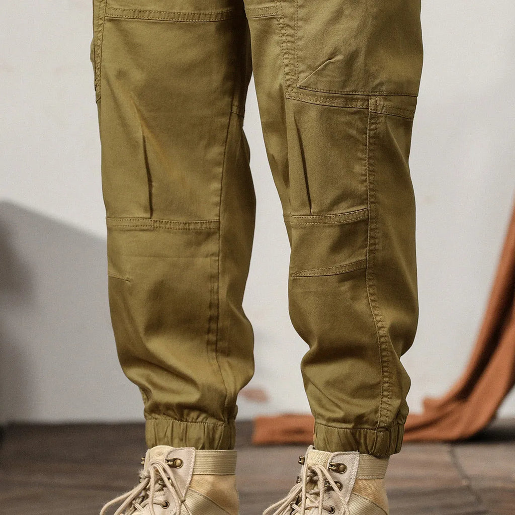 Men's cotton harem pants with ankle banded legs in khaki colour showing zip placket fly detail