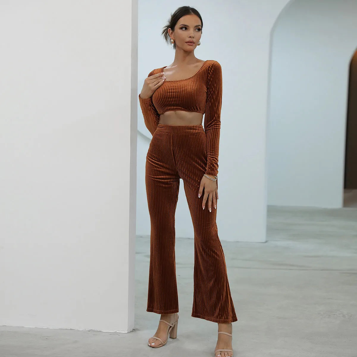 Caramel coloured long sleeve sweater and trouser casual set laid flat.
