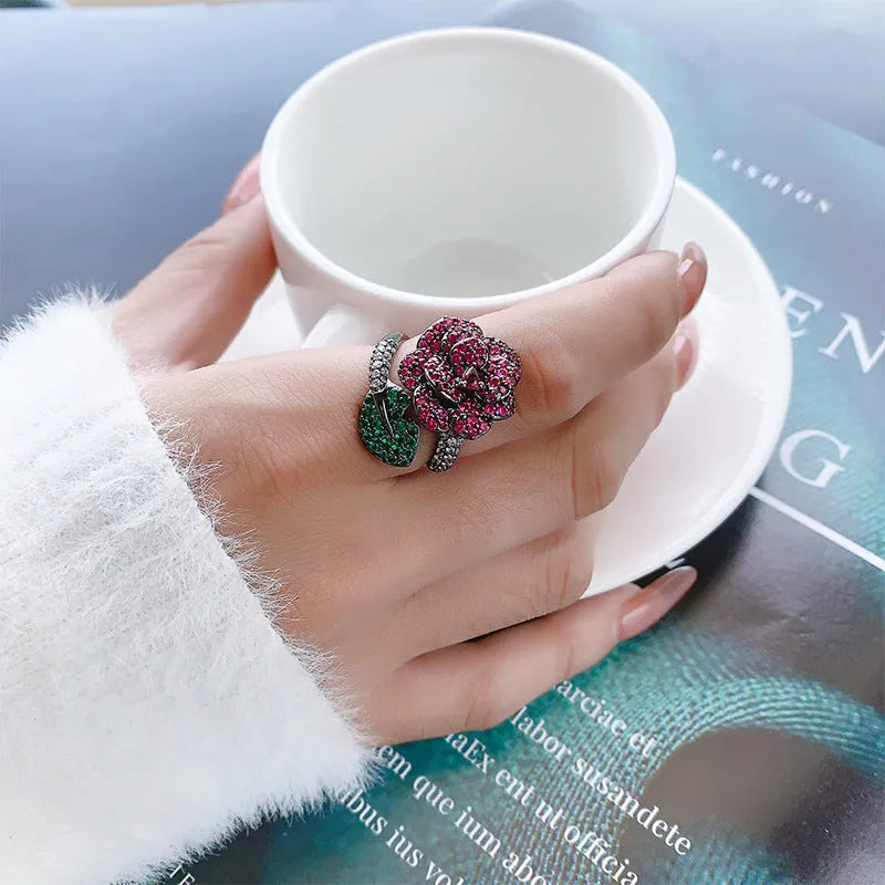 Black gold geometric flower ring with simulated red corundum centrepiece on copper base
