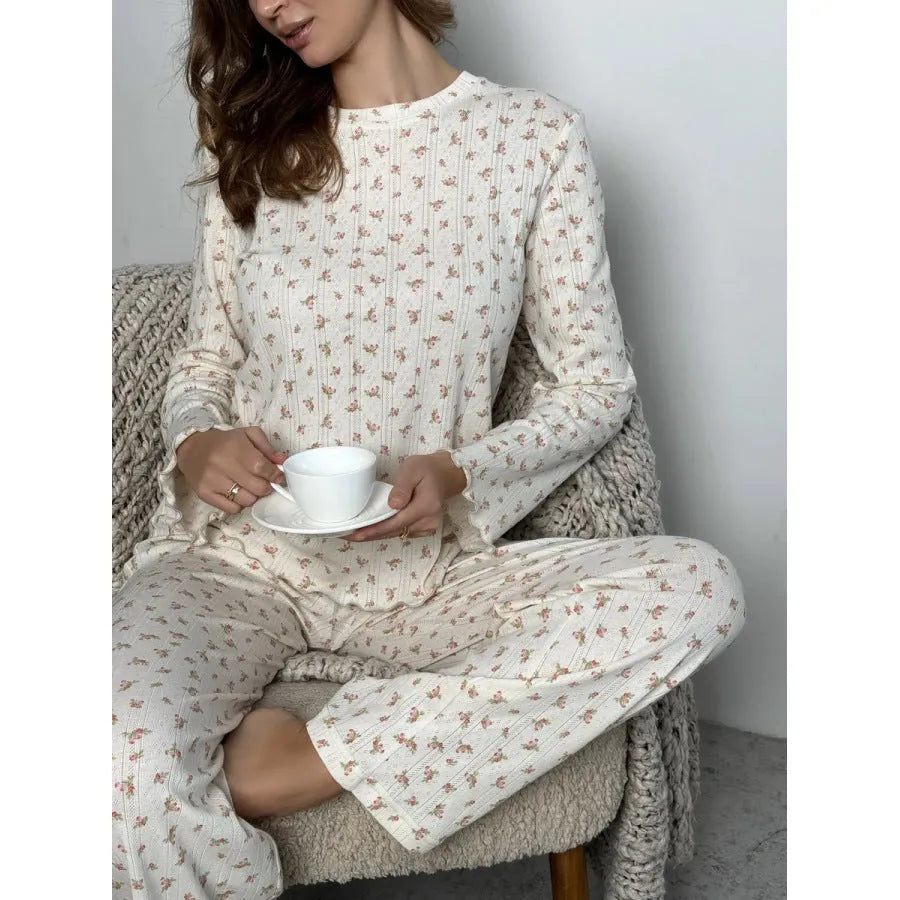 White women's floral print polyester two-piece suit with bell sleeve top and wide-leg trousers.