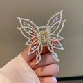 Butterfly-shaped hair barrettes for women with alloy construction and decorative rhinestone or pearl styling