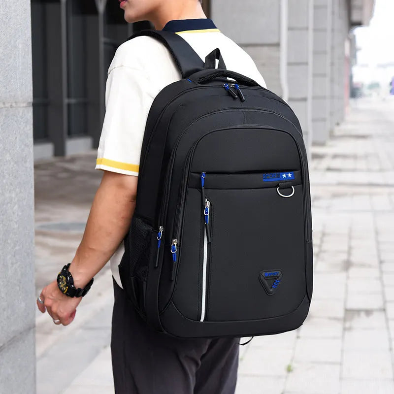 Men's Oxford cloth schoolbag in red with letter pattern, showing air pillow belt and large main compartment.